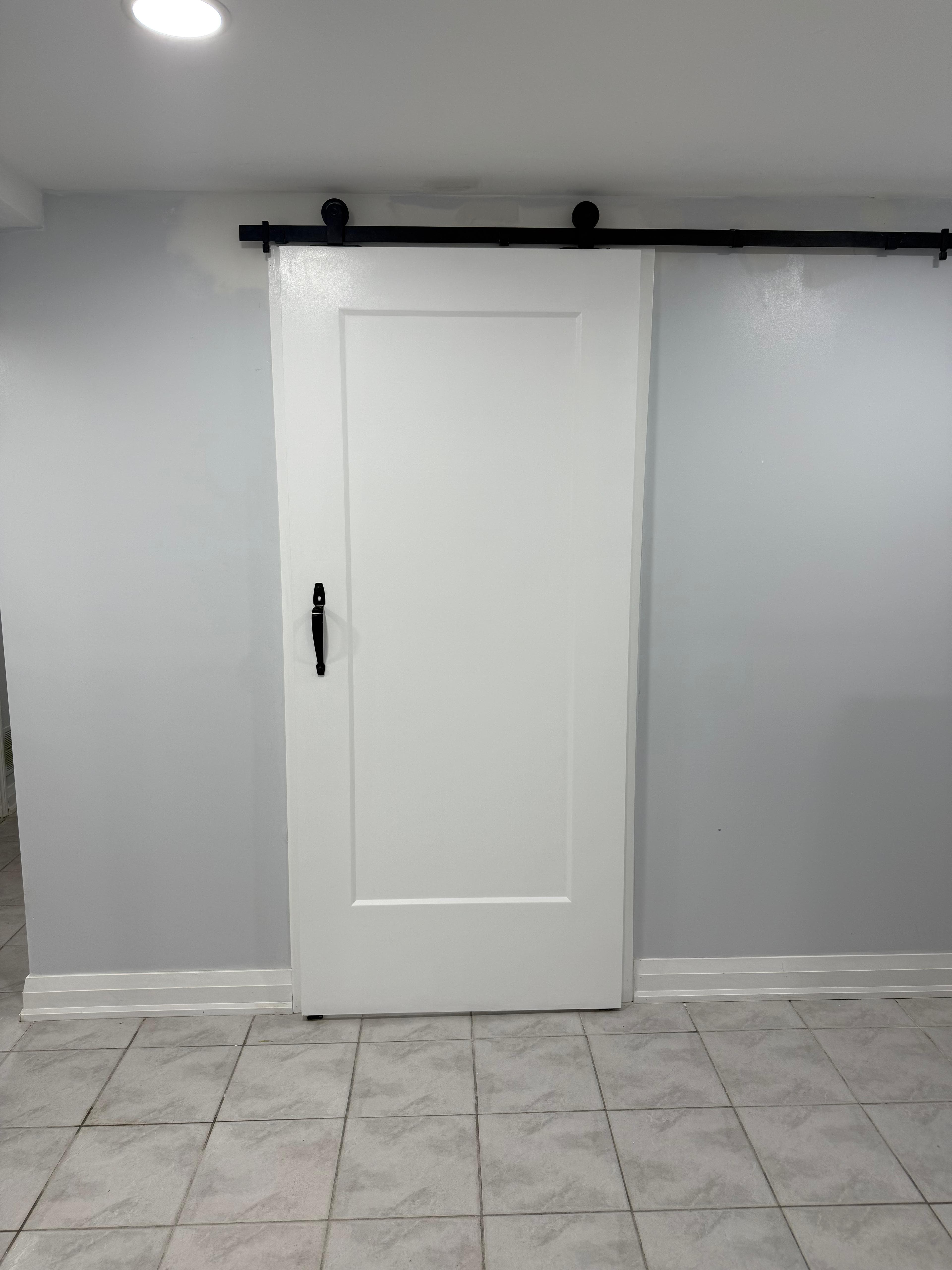 Barn door and piano styled stairs in basement, door remodel main floor in Brampton (after)