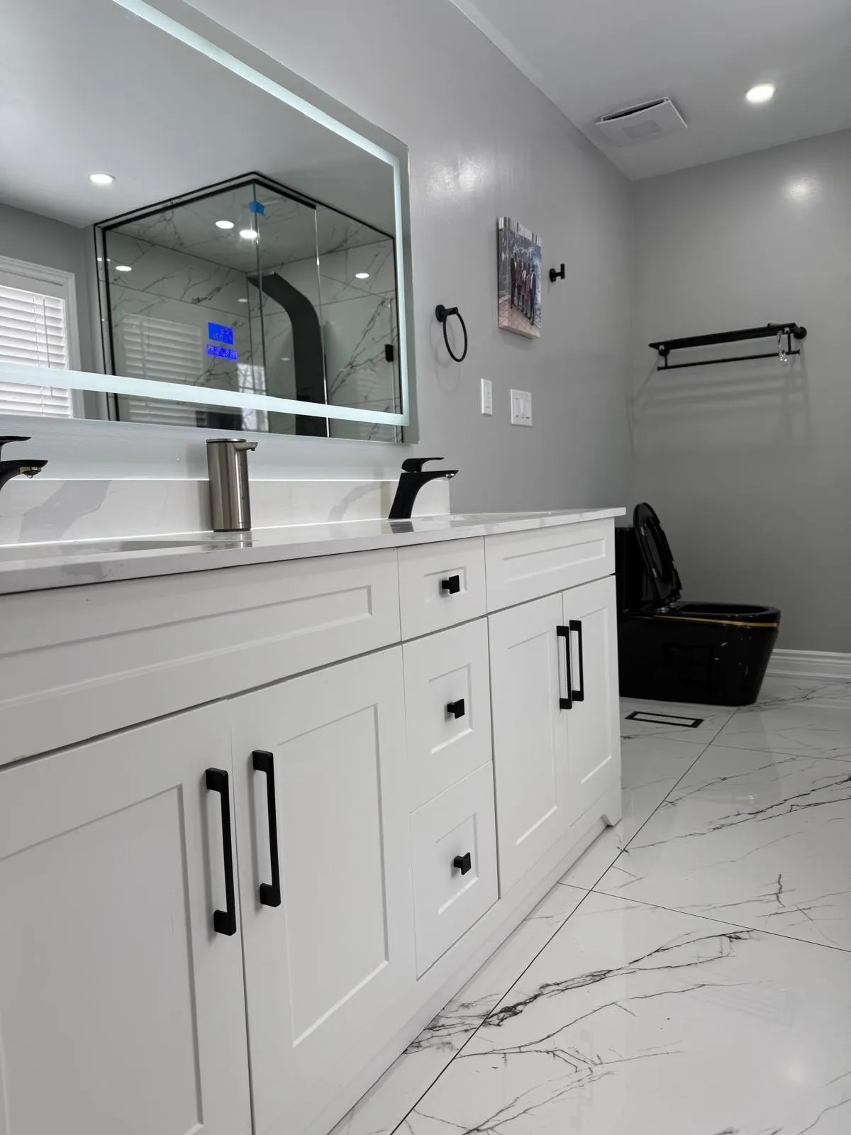 Open-concept Toronto living space remodeled with custom cabinetry and lighting